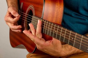 someone playing acoustic guitar