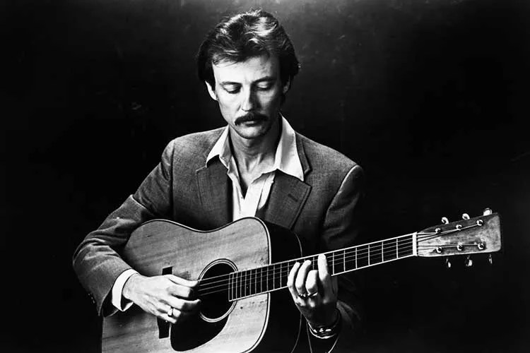 Tony Rice with a dreadnought acoustic guitar. Photo by Mark Farris